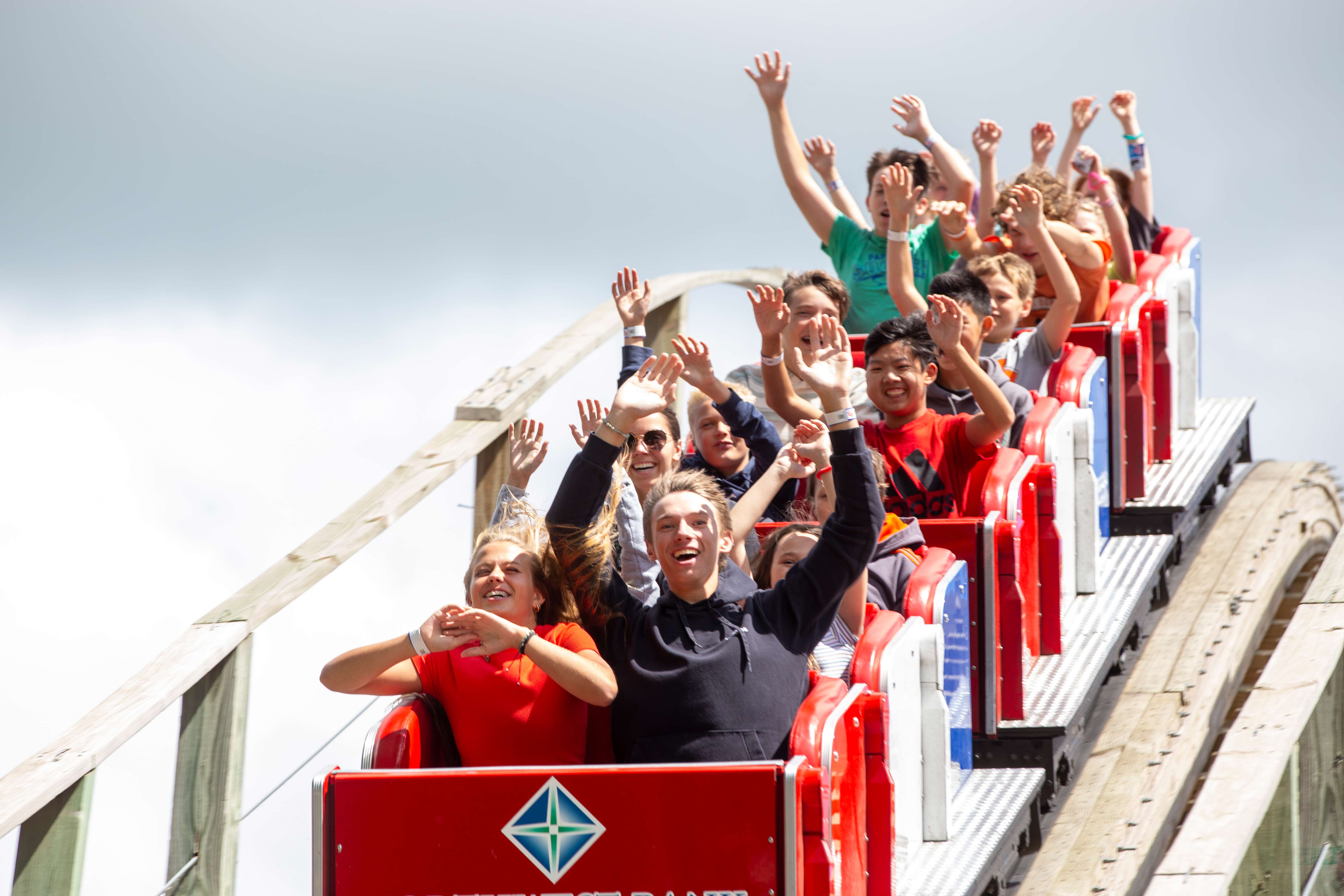 A young girl riding a tiger on the carousel.