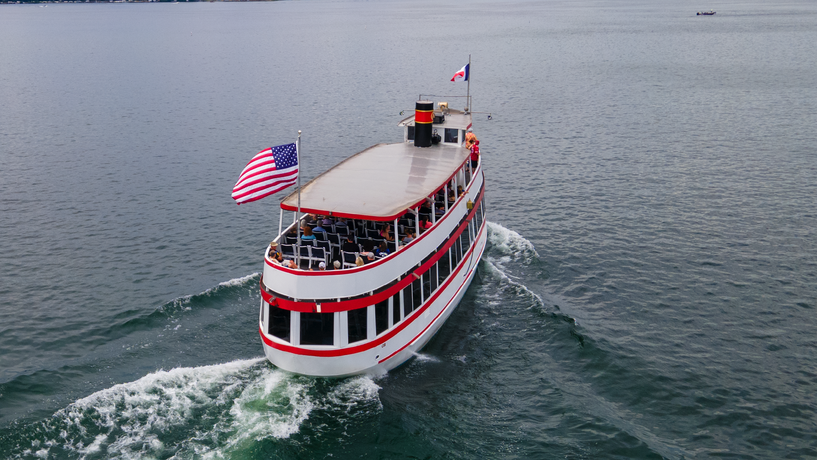 A young girl riding a tiger on the carousel.